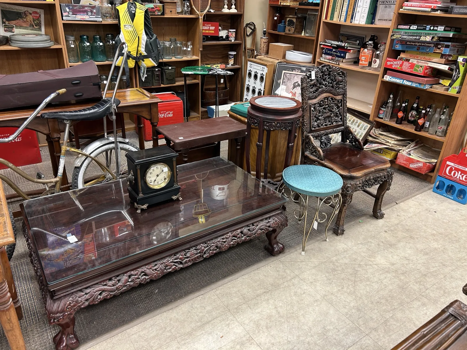 Wide view of furniture, vintage signs, games, books and collectables inside Krave Antiques Regina