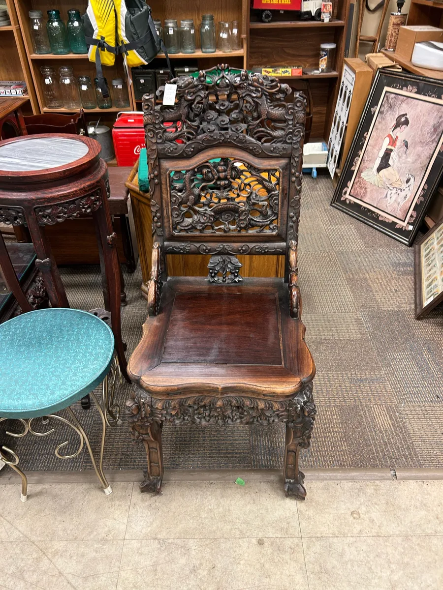 Elaborately carved antique wood chair at Krave Antiques Regina