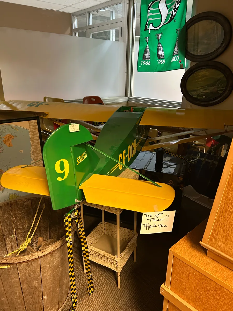 Green and yellow model airplane at Krave Antiques Regina